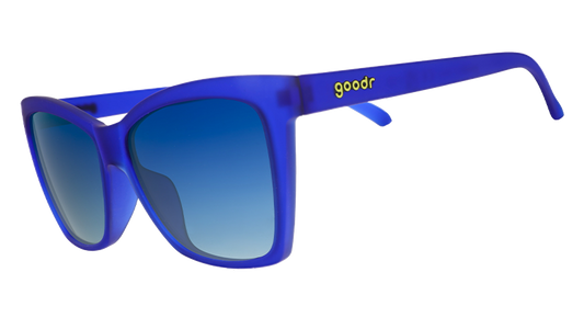 Three-quarter angle view of blue angled cat-eye sunglasses with blue gradient lenses.